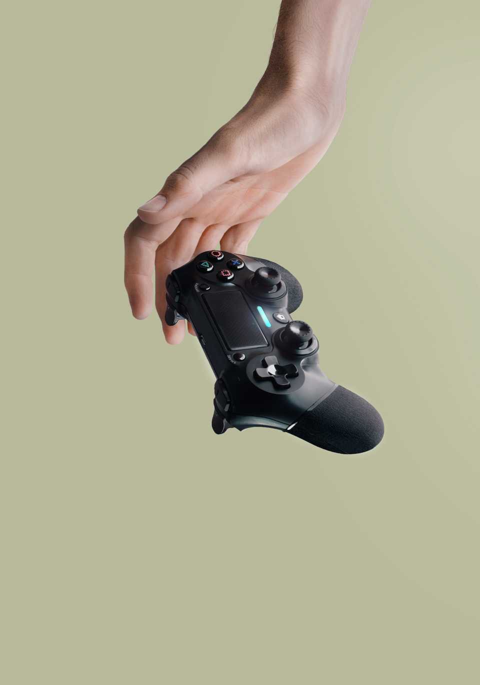 Hand reaching for Playstation gaming controller